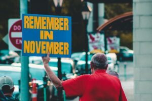 person holding remember in november sign