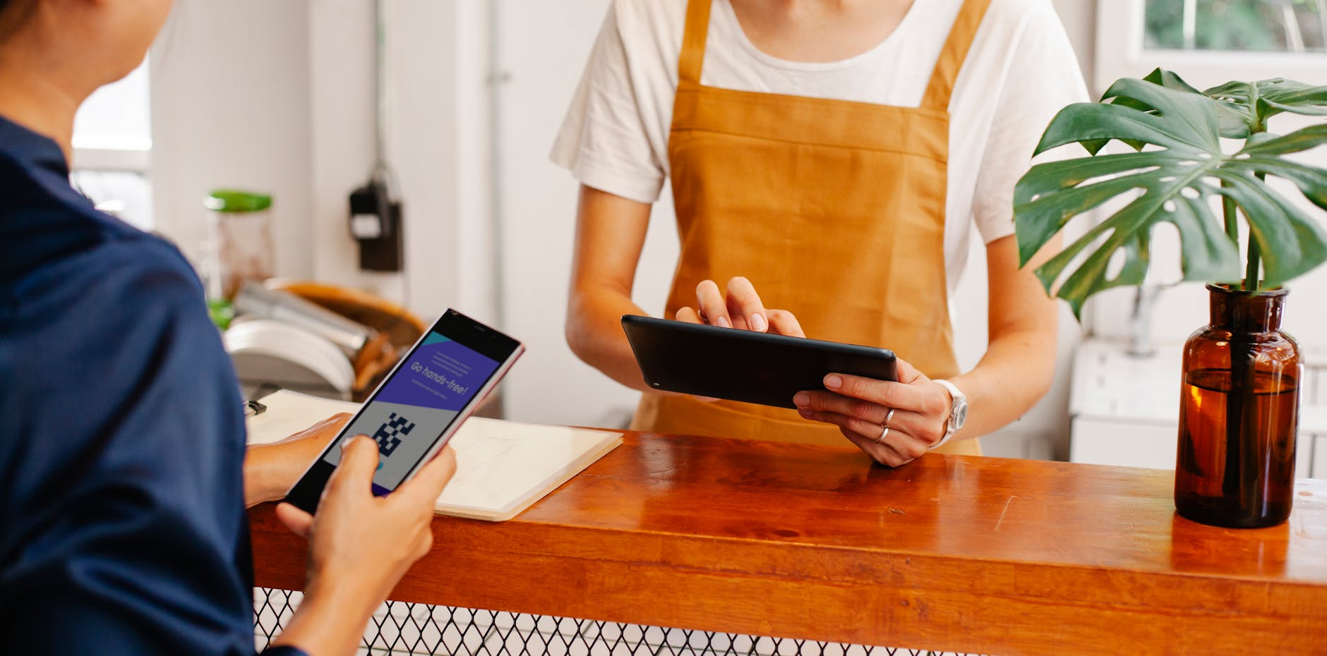 crop cafe coworkers using app on smartphone at work